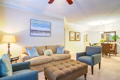 furnished living room with carpeted flooring and ceiling fan